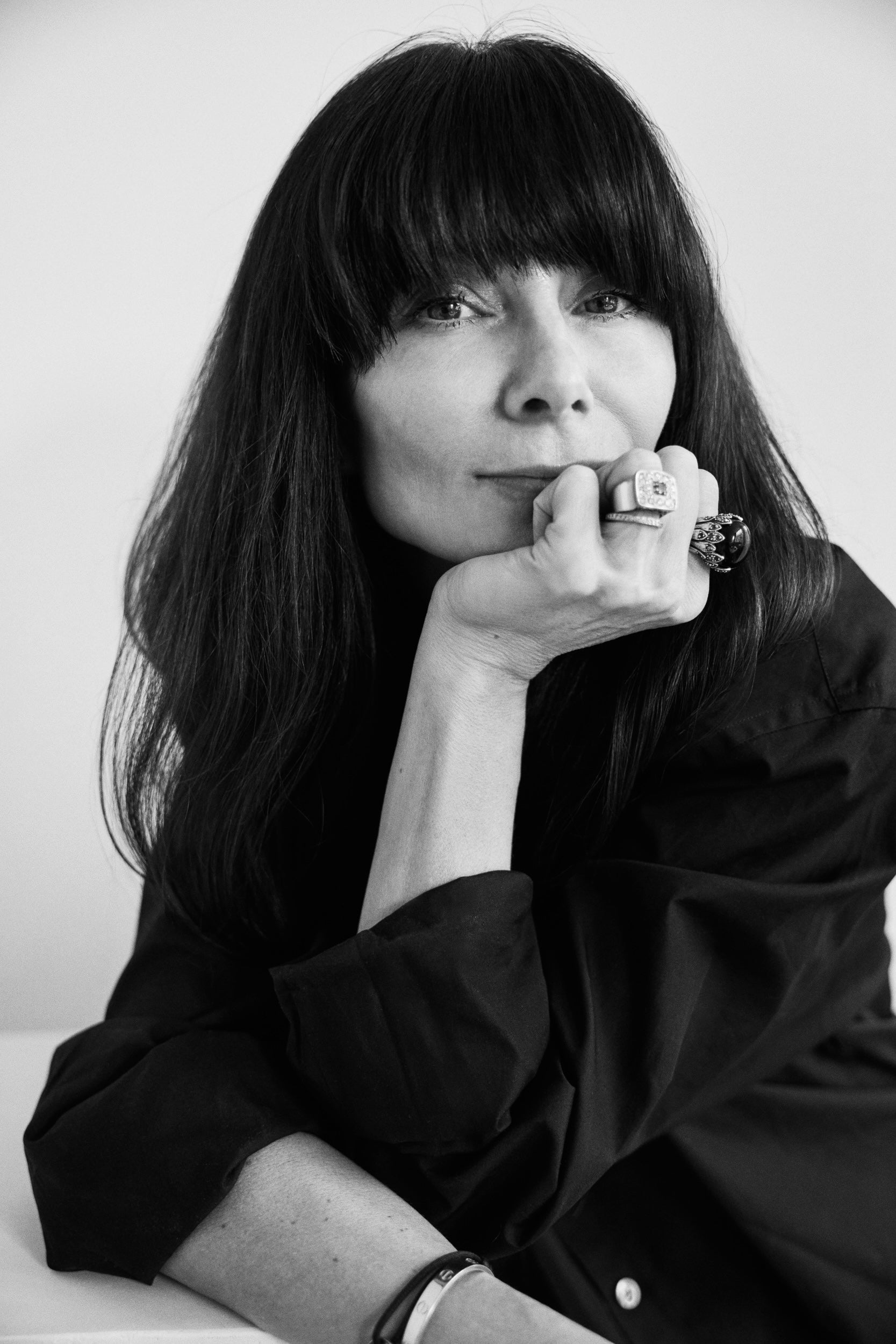 Black and white portrait of a woman with long hair and a black shirt.